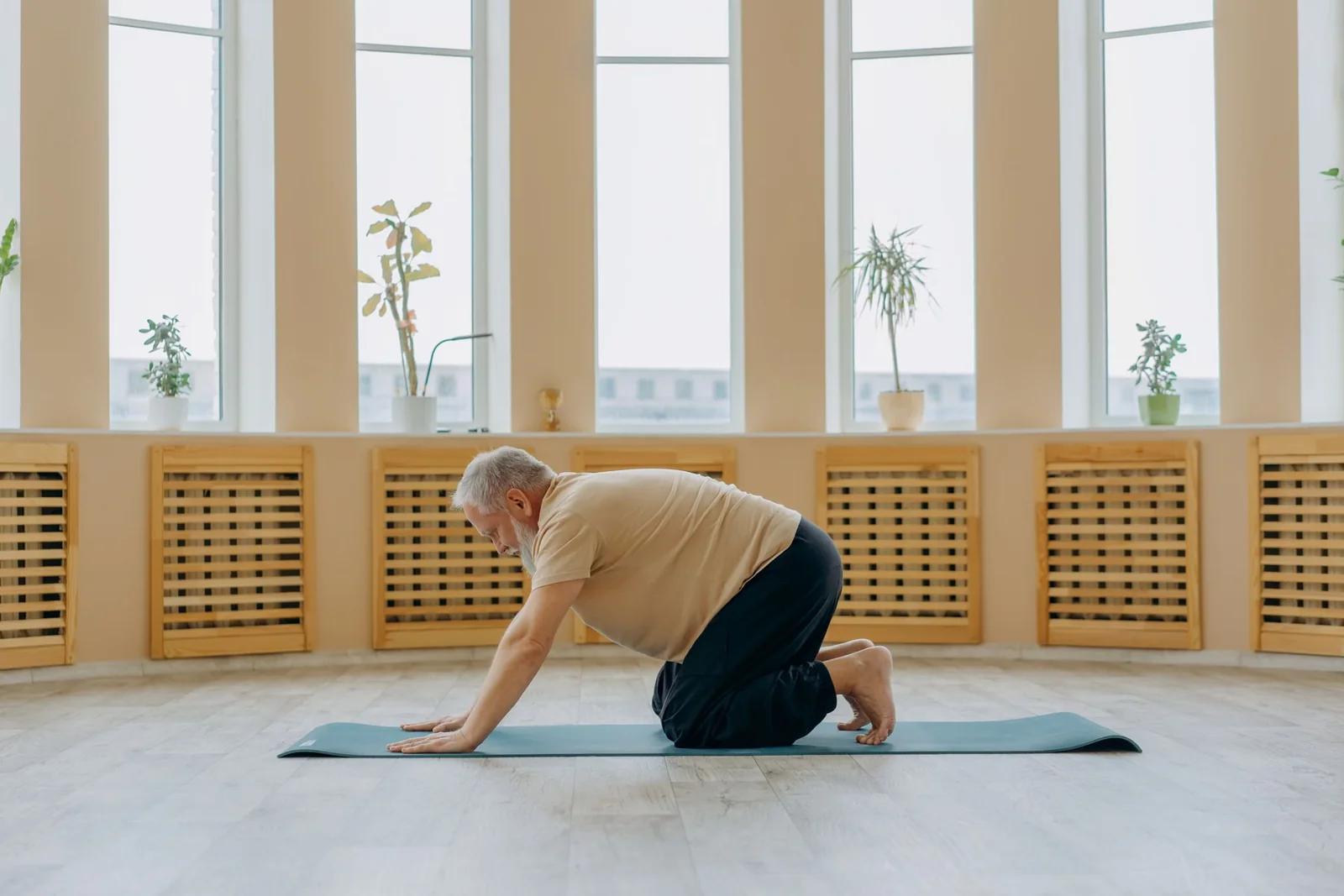 Mature man following a calm yoga and mobility routine
